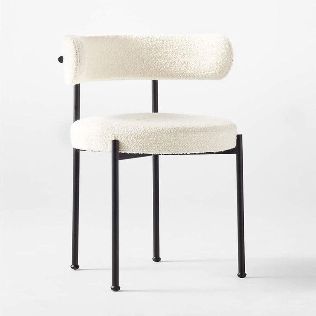 Aria Boucle Dining Chair with black powder-coated steel legs, upholstered in off-white boucle fabric, perfect for modern dining rooms.