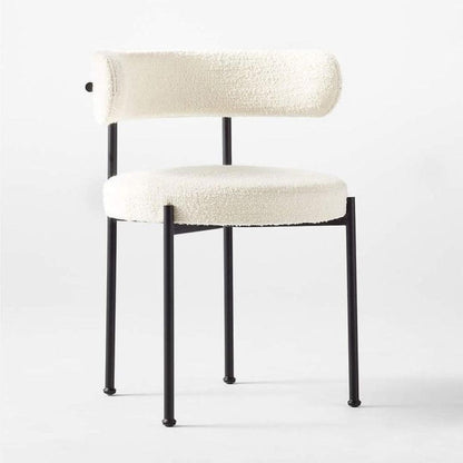Aria Boucle Dining Chair with black powder-coated steel legs, upholstered in off-white boucle fabric, perfect for modern dining rooms.