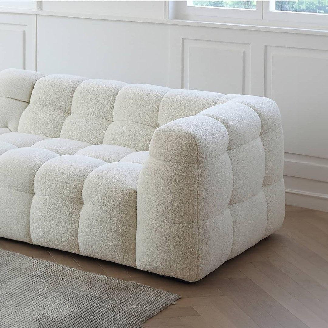 Side view of Boxy Cloud Sofa in off-white boucle fabric, showcasing its tufted design and modern aesthetic, perfect for homes in Dubai and UAE.